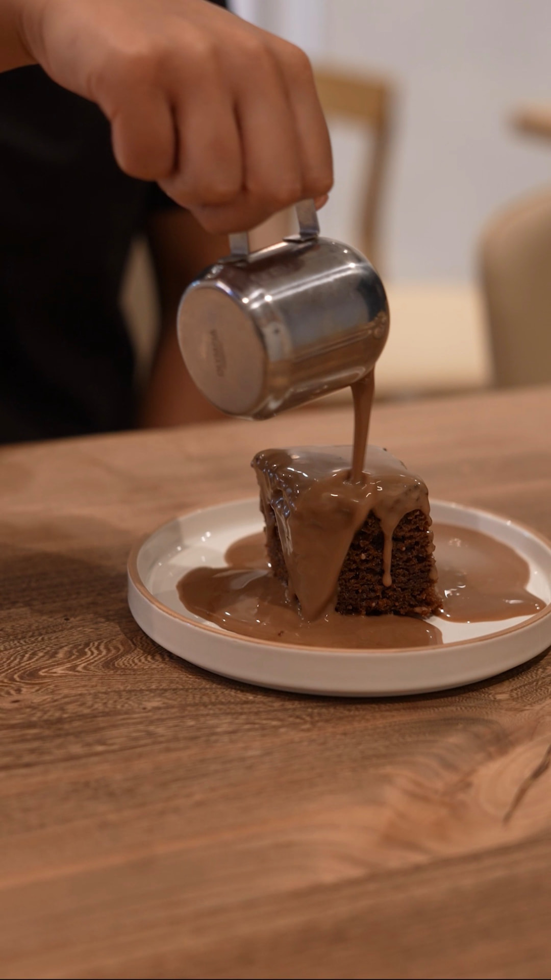 Warm toffee sauce poured over a sticky date cake